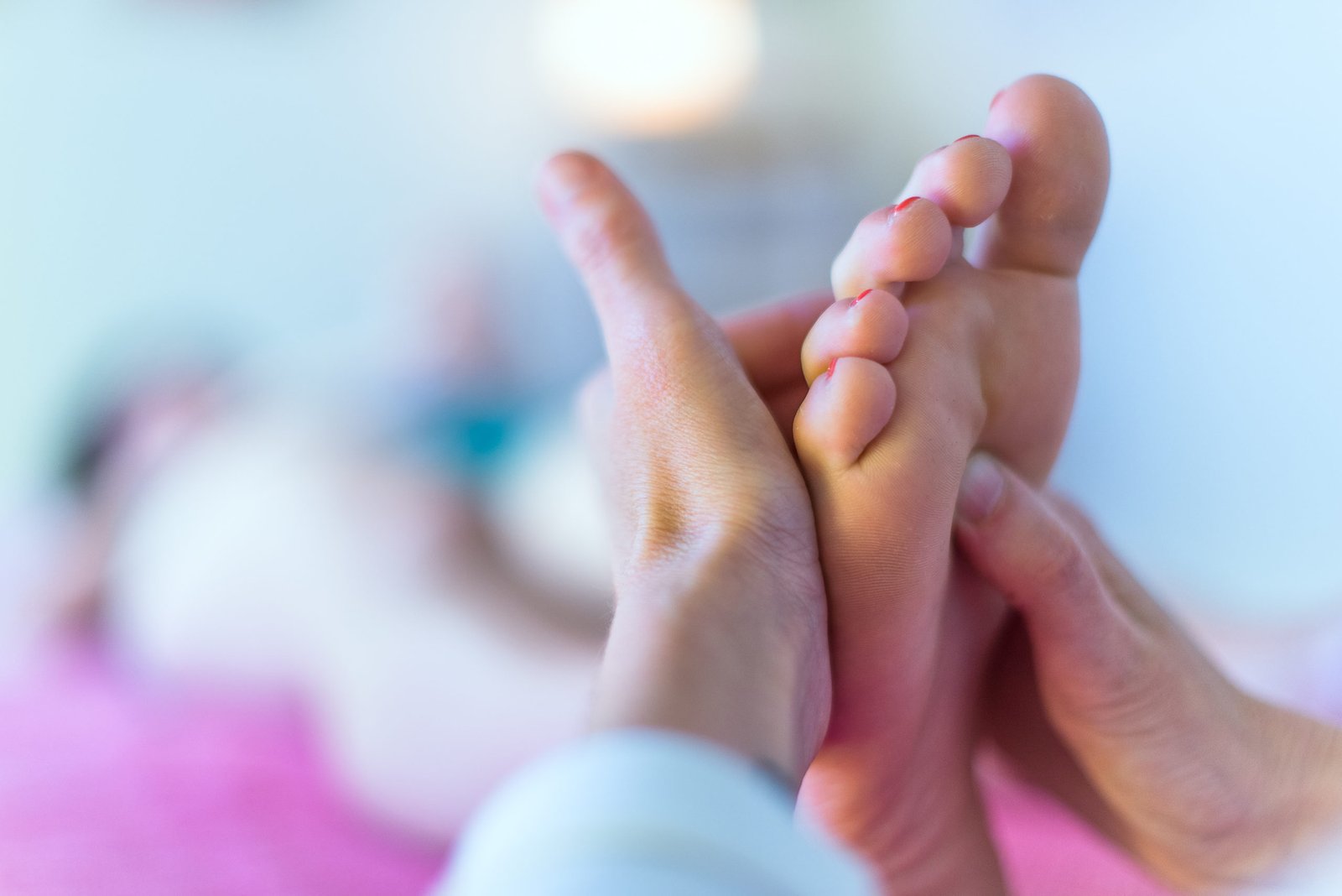 Therapist's hands massaging foot